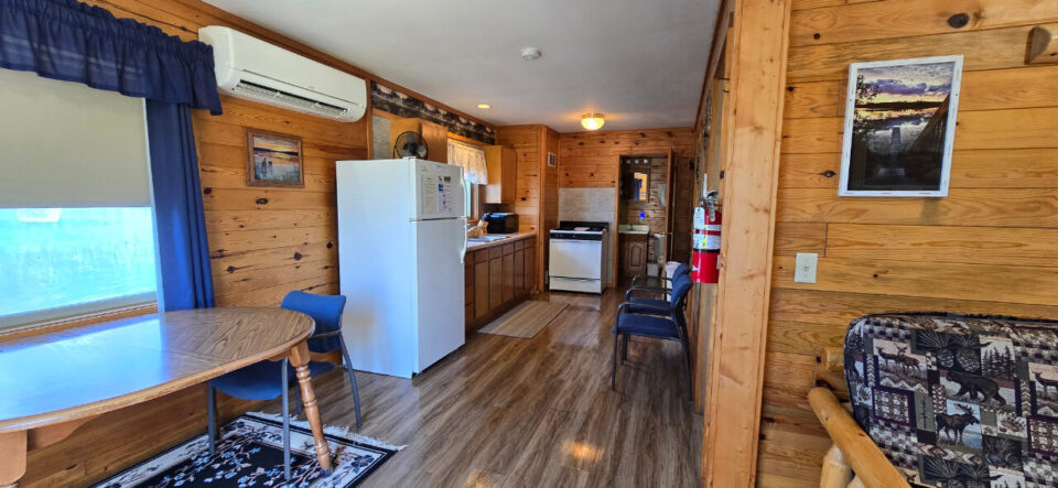 Cozy rustic cabin interior with kitchen and dining area