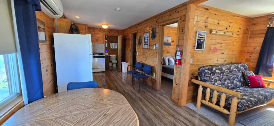Cozy rustic cabin interior with log furniture and kitchen